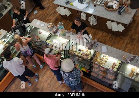 Young, Australia - December 01, 2012: View from above on interior of bakery, coffee shop with customers making orders in Young countryside town in rur Stock Photo