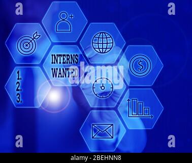 Writing note showing Interns Wanted. Business concept for temporary position with an emphasis on the job training Stock Photo