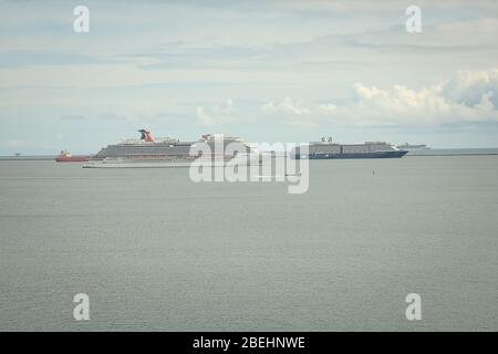 empty cruise ships moored off shore due to the shutdown of non-essential travel during the 2020 coronavirus pandemic .long beach calfornia,have suspen Stock Photo