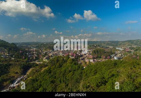 A small town during the clear sky day with cherry blossom and waterfall Stock Photo