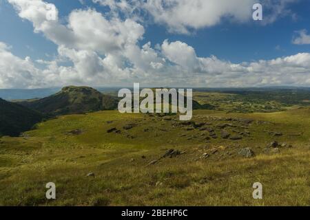 amazing landscape in the countryside with a stream flowing by and a vista view of the clouds and the mountains Stock Photo