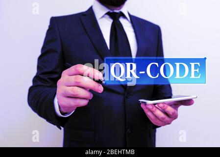 Handwriting text writing Qr Code. Conceptual photo the trademark for a type of matrix barcode A machinereadable code Male human wear formal work suit Stock Photo