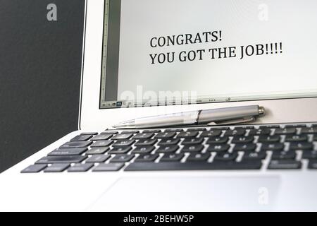 Congrats, you got the job. Typed words on computer screen. Good news concept. Stock Photo