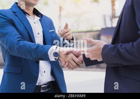 Two business man making handshake in the city. Business etiquette, congratulation, merger and acquisition concepts. Stock Photo
