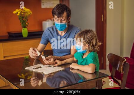 Happy Family Playing Board Game At Home. Stay at home due to quarantine. Coronovirus infection Stock Photo