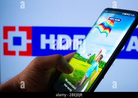 A mobile logged into the HDFC bank mobile application infront of the HDFC bank board Stock Photo