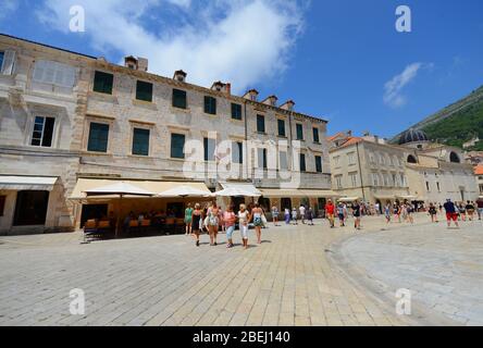 Tourist walking near the Cathedral and the Rectors palace in Dubrovnik's old town. Stock Photo