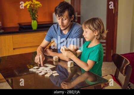 Happy Family Playing Board Game At Home Stock Photo