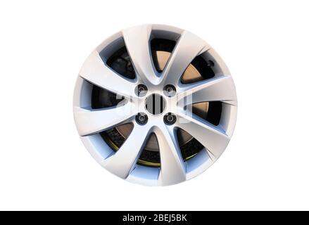 Modern alloy car disk without tire with four screws and brake disk isolated on white background. Stock Photo