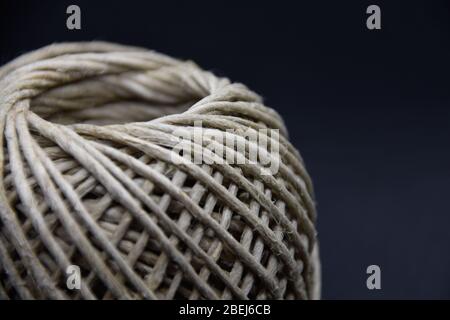 Ball of linen string isolated on black background Stock Photo