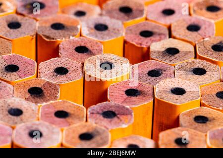 A Sharp Vivid macro image of the unsharpened ends on #2 Yellow pencils in tight grouping with voids in the groupings. Stock Photo