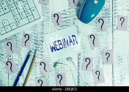 Conceptual hand writing showing Webinar. Concept meaning defined as seminar conducted over the Internet Web conferencing Writing tools and scribbled p Stock Photo