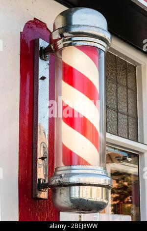 Traditional rotating red and white barbers pole. Stock Photo