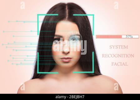 Biometric authentication concept. Facial recognition system of beautiful brunette woman on pink background Stock Photo