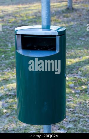 Green metal trash can in a park in Finland Stock Photo