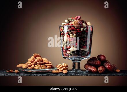 Dates and dried fruits, nuts and seeds. Copy space. Stock Photo