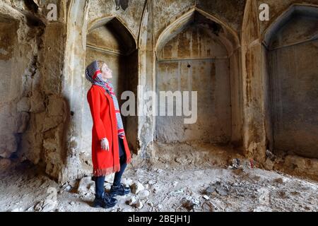 Iranian woman inside the ruins of Qatruyeh castle, Fars Province, Iran, Asia Stock Photo