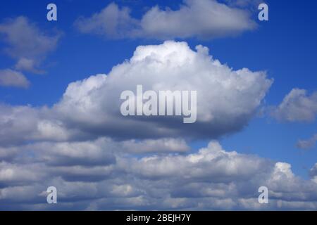 dramatic fluffy clouds and blue azure sky background Stock Photo