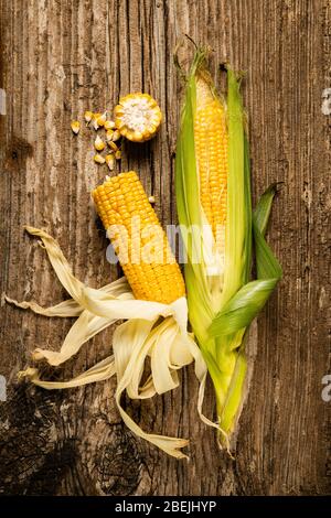 top view of some corn cobs on the rough wooden table. Still life Stock Photo