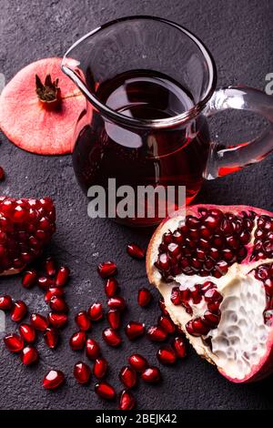 Juicy and fresh pomegranate, with seeds and pomegranate juice in a glass carafe Stock Photo