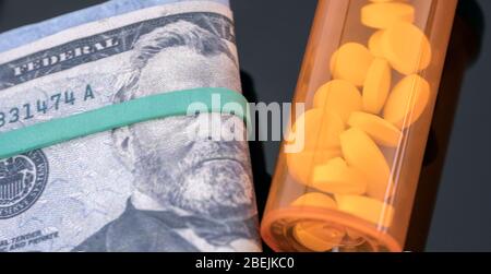 Boat of white pills along with tickets of dollar, concept of sanitary copayment Stock Photo