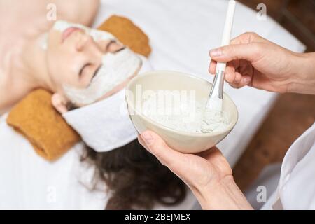 chemic facial peel mask. Cosmetology acne treatment. Young girl at medical Stock Photo