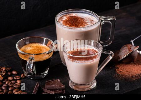 in the foreground, some types of espresso, latte macchiato and cappuccino with a sprinkling of cocoa powder. Stock Photo