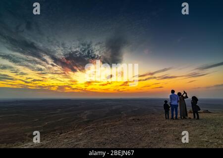 Tourist family on Edge of the World, a natural landmark and popular tourist destination near Riyadh -Saudi Arabia 26-Dec-2019 (Selective focus on the Stock Photo