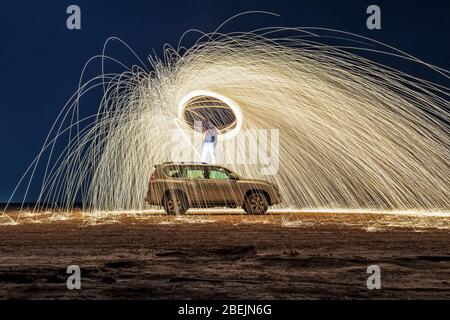 A steel wool on fire at night (night photography using a slow shutter speed) - selective focused. Stock Photo