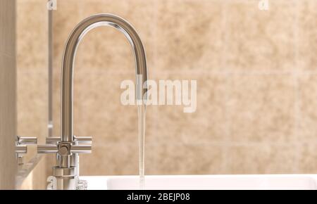 detail of a modern faucet in a bathroom from which water flows. selective focus. 3d render. Stock Photo