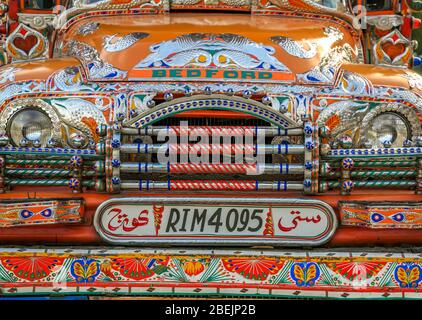 A very colourful old Bedford Truck, decorated with religious imagery and traditional art, in Northern Pakistan. Stock Photo