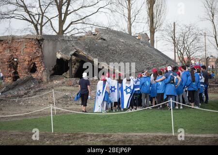 Oswiecim, Poland - 12 April 2018: International Holocaust Remembrance Day. Thousands of judes with Israeli flag come to Auschwitz to join and pray The Stock Photo