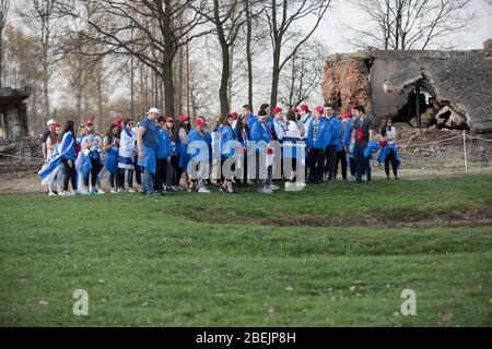 Oswiecim, Poland - 12 April 2018: International Holocaust Remembrance Day. Thousands of judes with Israeli flag come to Auschwitz to join and pray The Stock Photo