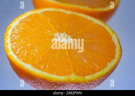 Close-up of  fresh orange slice over orange background. Bio and healthy food. Stock Photo