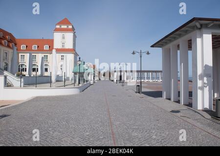 Ahlbeck, Germany. 12th Apr, 2020. Only a few people are on the beach promenade in front of the Kurhaus Hotel in the Baltic resort of Binz on the island of Rügen. Credit: Stefan Sauer/dpa-Zentralbild/dpa/Alamy Live News Stock Photo