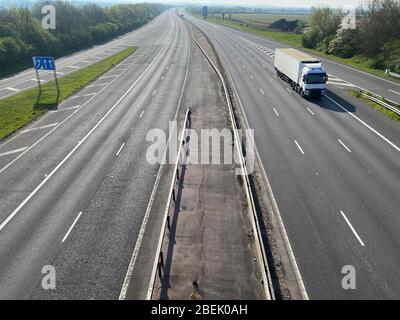 A single truck drives on an empty motorway during the coronavirus lockdown Stock Photo