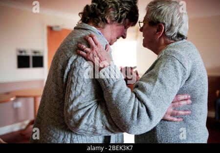 A resident and visitor waltz at a care home in Redcar, Teesside, UK. 24/2/2017. Photograph: Stuart Boulton. Stock Photo