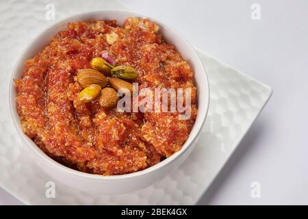 Delicious gajar ka halwa kept in a white bowl. Stock Photo