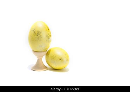 Two colored easter chicken eggs isolated on the white background. One is in holder. Stock Photo