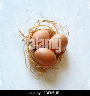 Healthy food concept. Three chicken eggs isolated on white background. Top view. Stock Photo