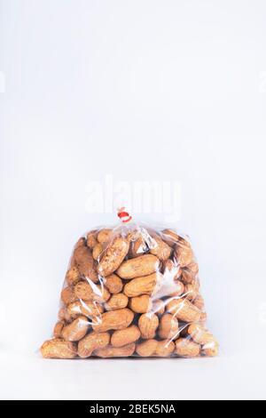 Groundnuts packed in a transparent plastic bag. Stock Photo