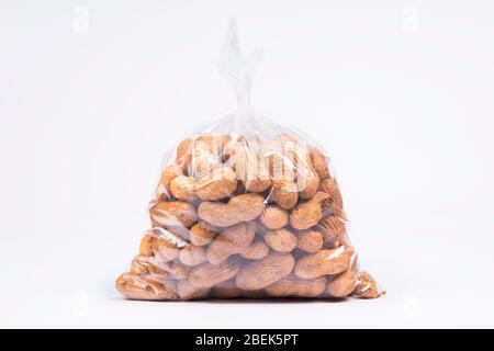 Groundnuts packed in a transparent plastic bag. Stock Photo