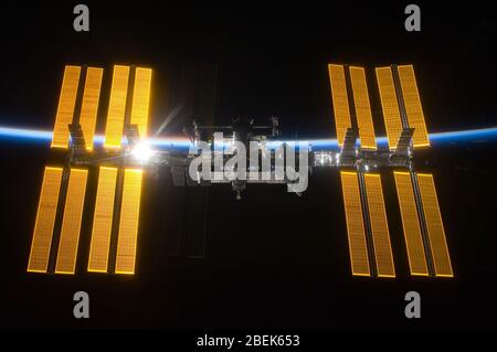 ISS - 25 March 2009 -- Backdropped by the blackness of space and the thin line of Earth's atmosphere, the International Space Station is seen from Spa Stock Photo