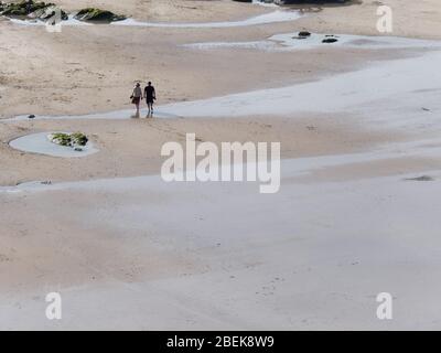 Newquay,Cornwall, Crantock beach and Fistral Bay solitary figures walk and exercise during Covid lockdown.. Credit: Robert Taylor/Alamy Live Stock Photo