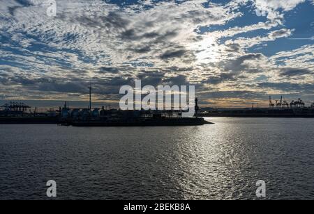 Stunning panoramic view of the Port of Hamburg with container terminal and the Köhlbrandbrücke bridge at Elbe river at sunset from roof of Dockland Stock Photo