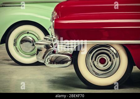 retro styled image of two vintage American cars parked next to each other Stock Photo