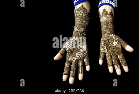 Beautiful Mehendi Design on hands in black background with copy space for text Stock Photo