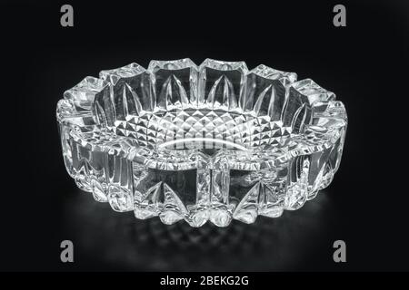 Close-up view of the glass ashtray isolated on black background Stock Photo