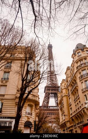 Parisian townhouses and the Eiffel Tower in Paris, France. Stock Photo