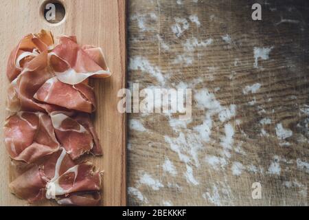 Spanish prosciutto on wooden board Stock Photo
